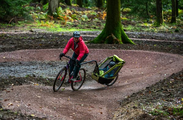 Family cycling with a buggy in the Forest of Dean photo credit Forestry England
