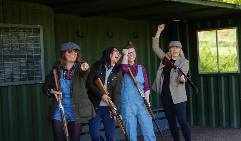 Group of ladies celebrating mid-game of laser clay pigeon shooting at Dean Laser Clay Ltd