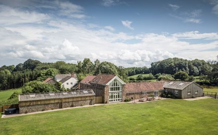 Stay at Lydney Park Estate and Gardens. Lodge Barn - aerial view of the generous outdoor space, quiet rural location and spacious accommodation at Lodge Barn.