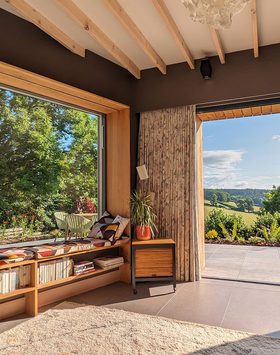 Nuthatch Retreat Lounge with panoramic window looking out at the Forest of Dean