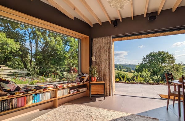 Nuthatch Retreat Lounge with panoramic window looking out at the Forest of Dean