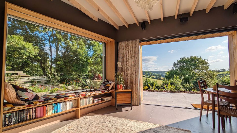 Nuthatch Retreat Lounge with panoramic window looking out at the Forest of Dean